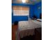 Blue bedroom with hardwood floors and a workspace at 2479 Kingsland Dr, Dunwoody, GA 30360