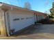 White garage door with windows, brick exterior, and long driveway at 2479 Kingsland Dr, Dunwoody, GA 30360