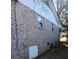 Brick house exterior with a basement access door at 2479 Kingsland Dr, Dunwoody, GA 30360