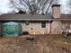 Backyard features a brick exterior with several windows and a modest lawn area at 2479 Kingsland Dr, Dunwoody, GA 30360