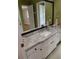 Bathroom featuring a granite countertop, white cabinets, and a large framed mirror at 2479 Kingsland Dr, Dunwoody, GA 30360