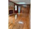 Spacious living room featuring hardwood floors, a brick fireplace, and wood paneling at 2479 Kingsland Dr, Dunwoody, GA 30360