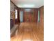 Spacious living room featuring hardwood floors, a brick fireplace, and wood paneling at 2479 Kingsland Dr, Dunwoody, GA 30360
