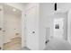 Hallway with laundry room and access to bedrooms with ample natural light at 3256 Durston Ct, Dacula, GA 30019