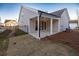Covered patio with access from the house and a fenced backyard at 517 Pearl St, Cumming, GA 30040