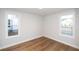 Well-lit bedroom with hardwood floors and two windows at 517 Pearl St, Cumming, GA 30040