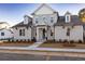 Two-story home with gray siding, a brick walkway, and landscaping at 517 Pearl St, Cumming, GA 30040