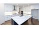 Modern kitchen with white cabinets, a large island, and stainless steel appliances at 517 Pearl St, Cumming, GA 30040