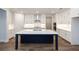 Modern kitchen with white cabinets, a large island, and stainless steel appliances at 517 Pearl St, Cumming, GA 30040