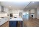 Modern kitchen with white cabinets, a large island, and stainless steel appliances at 517 Pearl St, Cumming, GA 30040