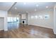 Spacious living room featuring hardwood floors, fireplace, and sliding glass doors at 517 Pearl St, Cumming, GA 30040