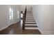 Elegant wooden staircase with dark wood railings and hardwood floors at 517 Pearl St, Cumming, GA 30040