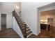 View of staircase from the foyer, showing kitchen in the background at 517 Pearl St, Cumming, GA 30040
