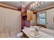 Bathroom with shower/tub combo, vanity, and window at 947 Pinbrook Dr, Lawrenceville, GA 30043