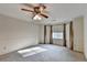 Spacious bedroom with a ceiling fan and window at 947 Pinbrook Dr, Lawrenceville, GA 30043