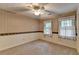 Bedroom with two windows, carpet, and ceiling fan at 947 Pinbrook Dr, Lawrenceville, GA 30043
