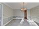 Formal dining room with bay window and chandelier at 947 Pinbrook Dr, Lawrenceville, GA 30043