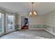 Formal dining room with bay window and chandelier at 947 Pinbrook Dr, Lawrenceville, GA 30043