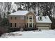 Two-story brick home with a snow covered front yard at 947 Pinbrook Dr, Lawrenceville, GA 30043