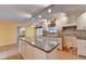 Kitchen features an island, granite counters, and white cabinets at 947 Pinbrook Dr, Lawrenceville, GA 30043