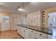 Kitchen boasts an island, white cabinets, and granite countertops at 947 Pinbrook Dr, Lawrenceville, GA 30043