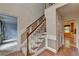 Hardwood staircase with wooden railing in the entryway at 947 Pinbrook Dr, Lawrenceville, GA 30043