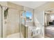 Spa-like bathroom with a soaking tub, walk-in shower, and window at 131 Bennett Farm Dr, Loganville, GA 30052