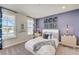 Spacious bedroom with a large bed, an accent wall, and plenty of natural light at 131 Bennett Farm Dr, Loganville, GA 30052