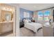 Bedroom with ensuite bathroom and blue accent wall at 131 Bennett Farm Dr, Loganville, GA 30052