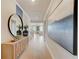 Entryway showcasing light hardwood floors, a mid-century modern console, and artwork at 131 Bennett Farm Dr, Loganville, GA 30052