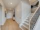 Bright entryway with hardwood floors, a stylish console table, and staircase at 131 Bennett Farm Dr, Loganville, GA 30052