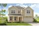 Two-story house with brick and siding, featuring a two-car garage and front porch at 131 Bennett Farm Dr, Loganville, GA 30052