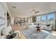 Open-concept great room and kitchen with light hardwood floors and large windows at 131 Bennett Farm Dr, Loganville, GA 30052