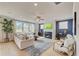 Spacious great room with a fireplace, large windows, and comfortable seating at 131 Bennett Farm Dr, Loganville, GA 30052