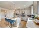 Modern kitchen with white quartz countertops, gray cabinets, and breakfast bar at 131 Bennett Farm Dr, Loganville, GA 30052