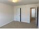 Bedroom with carpet, neutral walls and access to another room at 1238 Polk Xing, Mcdonough, GA 30252