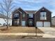 Brick two-story house with a two-car garage and landscaped yard at 1238 Polk Xing, Mcdonough, GA 30252