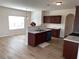 Eat-in kitchen with hardwood floors, island, and stainless steel appliances at 1238 Polk Xing, Mcdonough, GA 30252