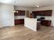 Spacious kitchen with an island, stainless steel appliances, and hardwood floors at 1238 Polk Xing, Mcdonough, GA 30252