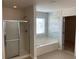 Main bathroom with soaking tub, shower, and tile flooring at 1238 Polk Xing, Mcdonough, GA 30252