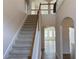Elegant staircase with a light beige carpet and wooden railings at 1238 Polk Xing, Mcdonough, GA 30252