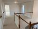 Spacious upper hallway with carpeting and access to bedrooms at 1238 Polk Xing, Mcdonough, GA 30252