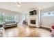 Bright living room with hardwood floors, fireplace and large windows at 2362 Browns Mill Se Rd, Atlanta, GA 30315