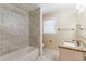 Bathroom with granite countertop, marble tile, and bathtub at 2617 Miriam Ln, Decatur, GA 30032