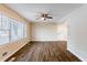 Living room with hardwood floors, large windows, and ceiling fan at 2617 Miriam Ln, Decatur, GA 30032