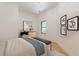 Light-filled bedroom with wood floors and a bench at the foot of the bed at 3840 Wieuca Ne Ter, Atlanta, GA 30342