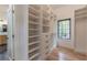 Bright walk-in closet with custom built-ins and window at 3840 Wieuca Ne Ter, Atlanta, GA 30342