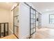 Modern hallway with glass barn doors and light hardwood floors at 3840 Wieuca Ne Ter, Atlanta, GA 30342