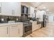 Modern kitchen with white cabinets, black tile backsplash, and stainless steel appliances at 3840 Wieuca Ne Ter, Atlanta, GA 30342