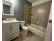 Updated bathroom with a white vanity and tiled shower/tub at 4626 Midridge Dr, Norcross, GA 30093